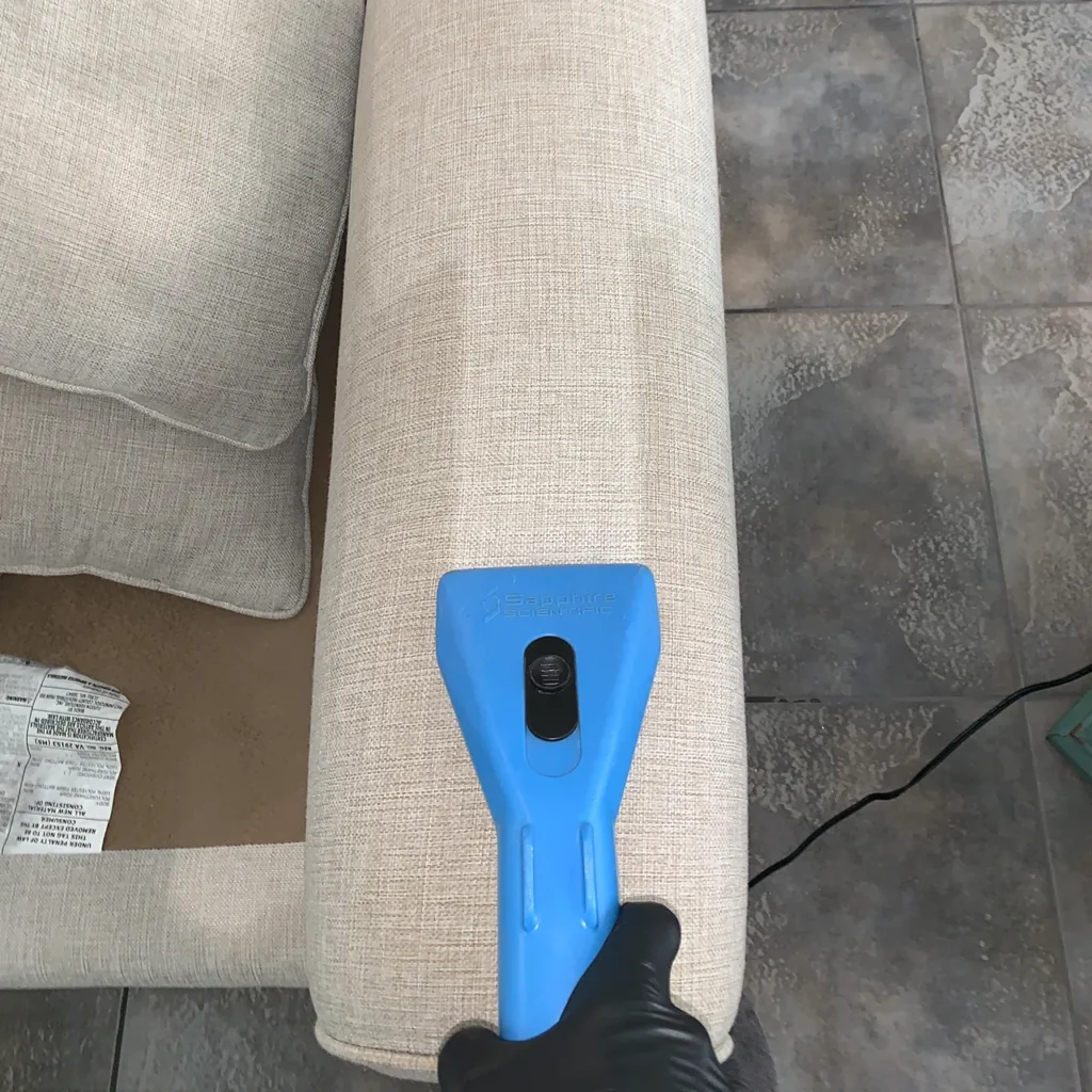 Sofa arm being cleaned, showing the clean line